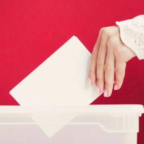 woman-putting-card-mock-up-in-box-for-election